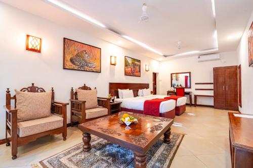 a hotel room with a bed and a table at PrideInn Hotel Nyali in Mombasa