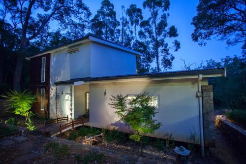 a small white house with a garage at night at Zen on the River Lux 3BR with Japanese Deep Bath Walk to Down Town in Margaret River Town