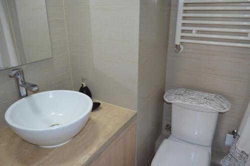 a bathroom with a white sink and a toilet at Departamento Termas de Chillan in Nevados de Chillan