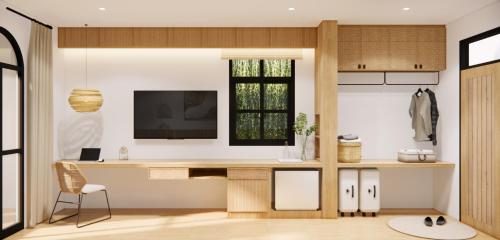 a home office with a desk and a window at The Motifs Eco Hotel - SHA Extra Plus in Chanthaburi