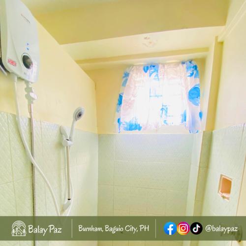 a shower in a bathroom with a shower curtain at Spacious 2BR Family Home - Narra Unit by Balay Paz in Baguio