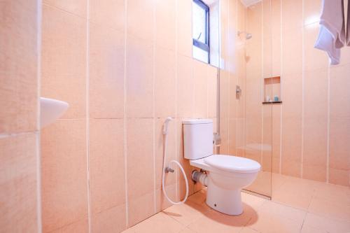 a bathroom with a toilet and a shower at PrideInn Hotel Nyali in Mombasa