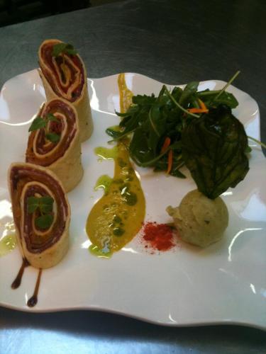 a white plate with food on a table at Mercure Strasbourg Aéroport in Ostwald