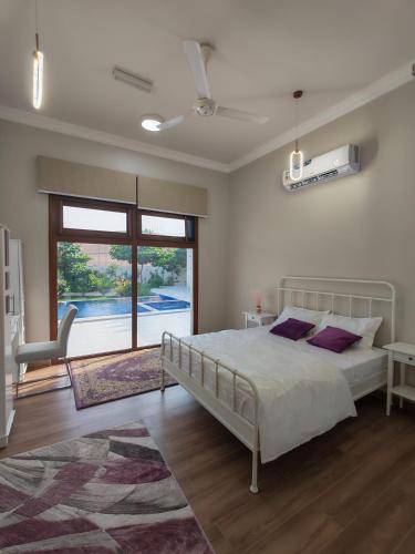 a bedroom with a bed and a large window at استراحة غوانا 