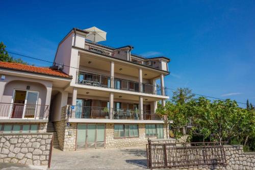 an apartment building with a fence in front of it at Apartment in Crikvenica 34973 in Sopaljska