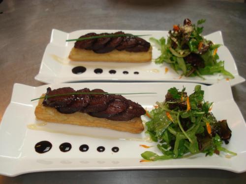 three plates of food with meat and a salad at Mercure Strasbourg Aéroport in Ostwald