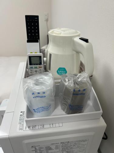 a white appliance with a blender on top of a refrigerator at 未来ホテル 伊勢崎 MiraiHotel Isesaki in Isesaki