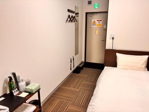 Postel nebo postele na pokoji v ubytování 未来ホテル MiraiHotel