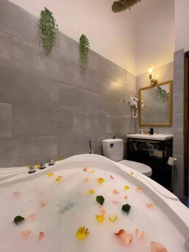a bathroom with a bath tub with debris on it at Studio Old Town with Jacuzzi and View in Bucharest