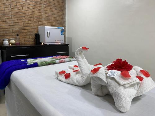 two swans made out of towels sitting on a bed at Chateux de atlantique Hotel in Lagos