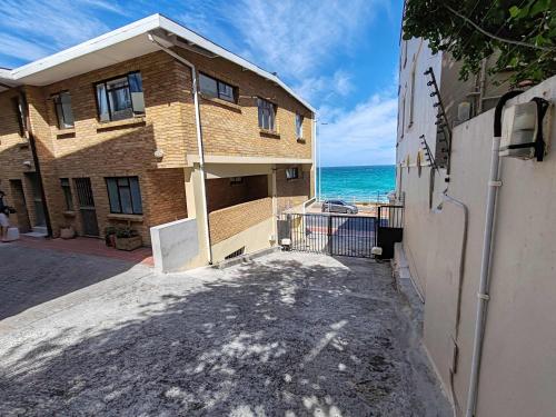 a brick building with the ocean in the background at Ocean Blue Stay in St James