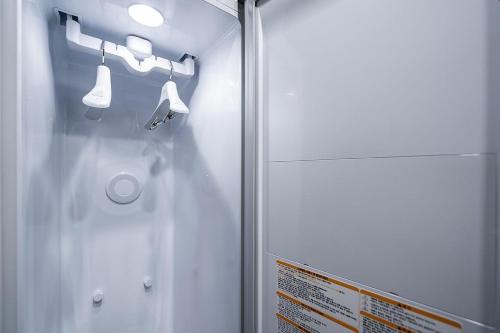 a bathroom with a shower with lights and a sign at Jeonju Nabi in Jeonju