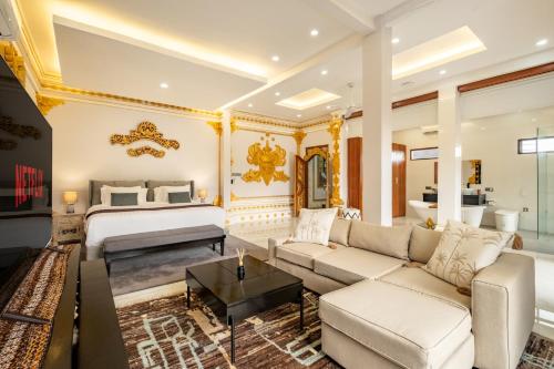 ein Wohnzimmer mit einem Bett und einer Couch in der Unterkunft Private Luxe 5BR Swarna Mandapa By Orivista in Uluwatu