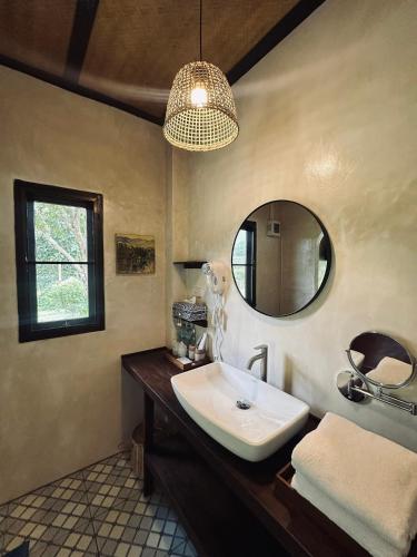 a bathroom with a sink and a mirror at เวียงปันดาว Viengpundao เชียงดาว in Ban Tham