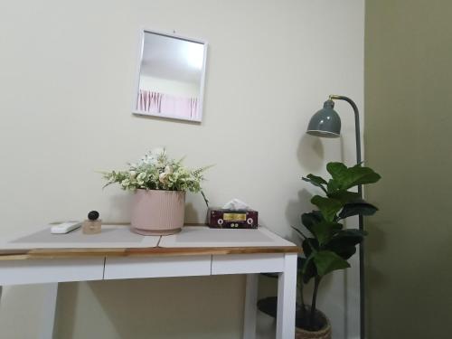 a desk with a mirror and a plant on it at D2303 Camellia Stay, Alanis Near KUL Airport in Sepang