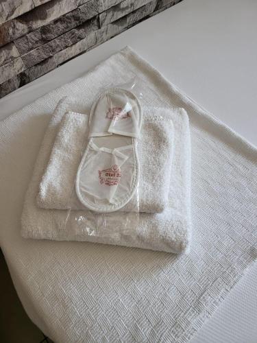 a white napkin with a pair of shoes on it at OTEL 22 EDiRNE in Edirne