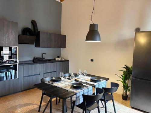 a kitchen with a table with wine glasses on it at Elegante appartamento nel cuore di Bassano in Bassano del Grappa