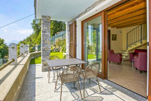 a table and chairs on the balcony of a house at Villa Graziosa in Trarego