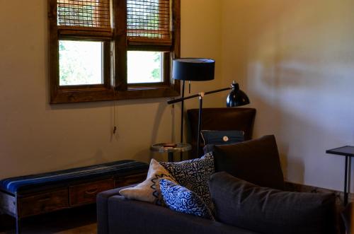 a living room with a couch and a lamp at Escalante Outfitters in Escalante