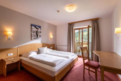 ヴェステンドルフにあるAppartements Barbaraのベッドと机があるホテルの部屋