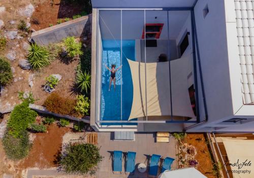 an overhead view of a man in a swimming pool at Villa Marisari in Otok Lastovo