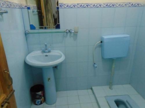 a white bathroom with a sink and a toilet at Star Rise Hotel in Naran