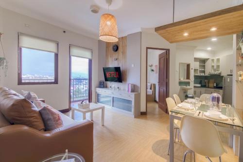 a living room with a couch and a table at 2BR Apartment Majesty W Pool in Bandung