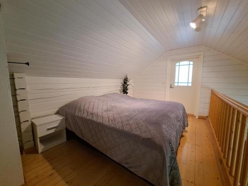a bedroom with a bed in a room with a window at Lusseeri in Kalajoki