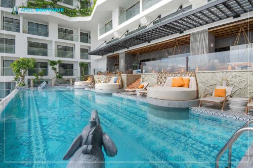 a pool with an elephant in the middle of a building at Mandala Wins Hotel Phú Yên in Phước Hậu