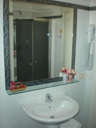 a bathroom with a sink and a mirror at Hotel Le Mura e Residence in Città di Castello