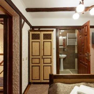 a bedroom with a door and a bathroom with a toilet at Krucha in Bukovel