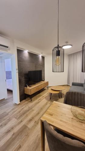 a living room with a couch and a table at Kings Apartments in Tiberias