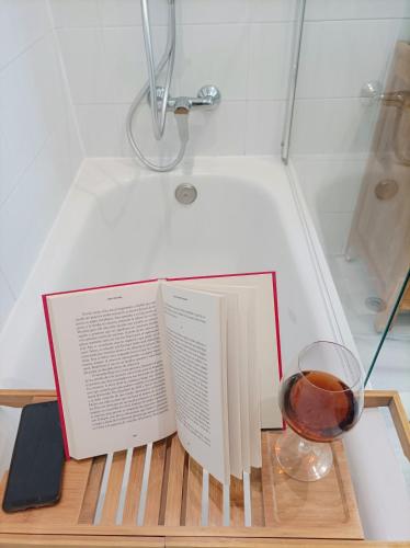 a book and a glass of wine sitting on a table at Casa Micho in Tomares