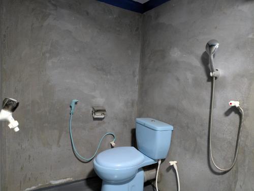 a bathroom with a toilet and a shower at Manha Blue Villa Arugambay in Arugam Bay