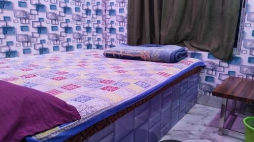 Postel nebo postele na pokoji v ubytování New SRI GURU BHAVAN