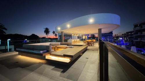 a building with a lit up rooftop at night at Makia Beach experience 107 D Premium in Ipojuca
