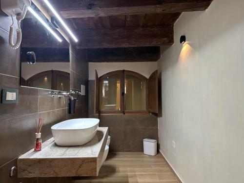a bathroom with a large tub and a sink at al Vico Bedrooms in Crotone