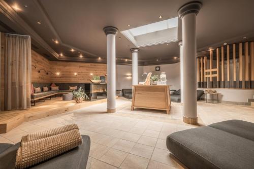 a room with a bed and a couch and a table at Hotel Pirchnerhof in Reith im Alpbachtal