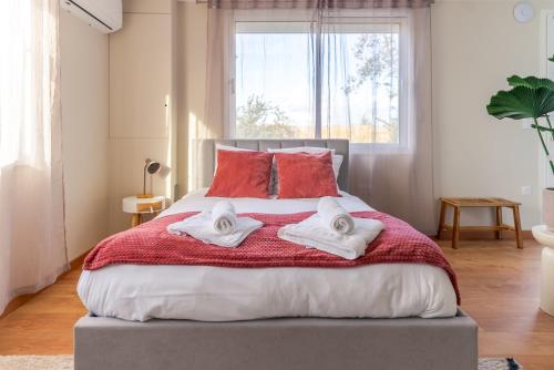 a bedroom with a large bed with towels on it at La simplicité, climatisé avec entrée autonome in La Ferté-Gaucher