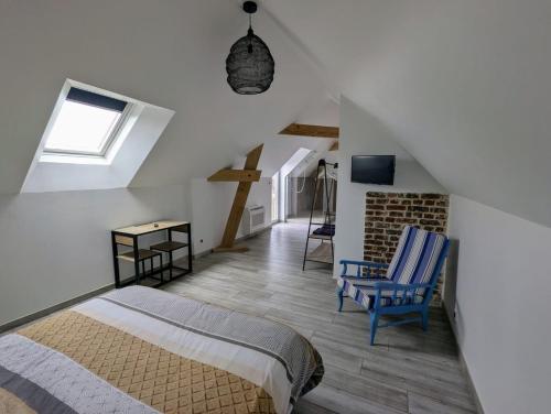 a bedroom with a bed and a chair in a attic at LE CHARME D OGNES in Ognes