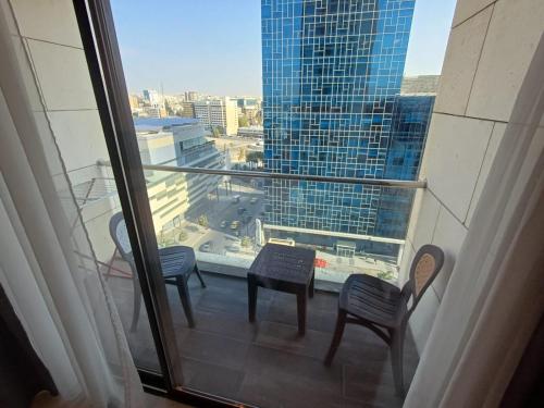 a balcony with chairs and a view of a city at Studio at Damak Jordan in Amman