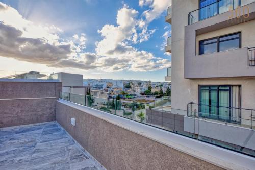a balcony with a view of a city at The Pender LUX HUB - 4BR villas with Pool, WIFI & AC by 360 Estates in St. Julianʼs
