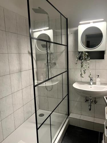 a bathroom with a shower and a sink at Somewhere2Stay Apartment in Oberhausen City in Oberhausen