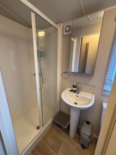 a bathroom with a shower and a sink at 64, Belle Aire Caravan Park, Sleeps 6, Bed Linen and Towels Included, Free WiFi, Pets Welcome with onsite clubhouse in Great Yarmouth