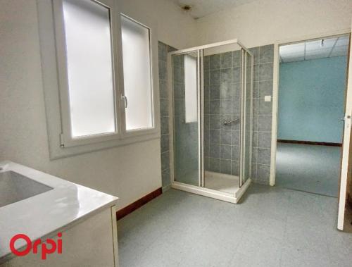 a bathroom with a shower and a glass door at L'Arbre de Vie in Montmarault