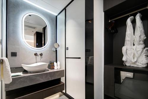 a bathroom with a sink and a mirror at 泊云小筑民宿 in Datong