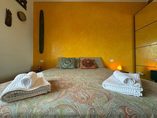 a bedroom with a bed with towels on it at Venezia-Mestre Train Station Relax Suites in Venice