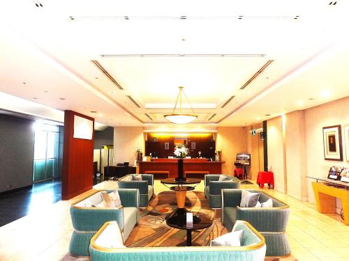 a lobby with chairs and a table in a hotel at Yokohama Techno Tower Hotel in Yokohama
