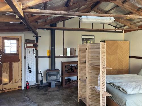 a bedroom with a bed and a wood stove at River meets the Sea in Stockton