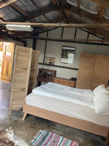 a bedroom with a large bed and wooden furniture at River meets the Sea in Stockton